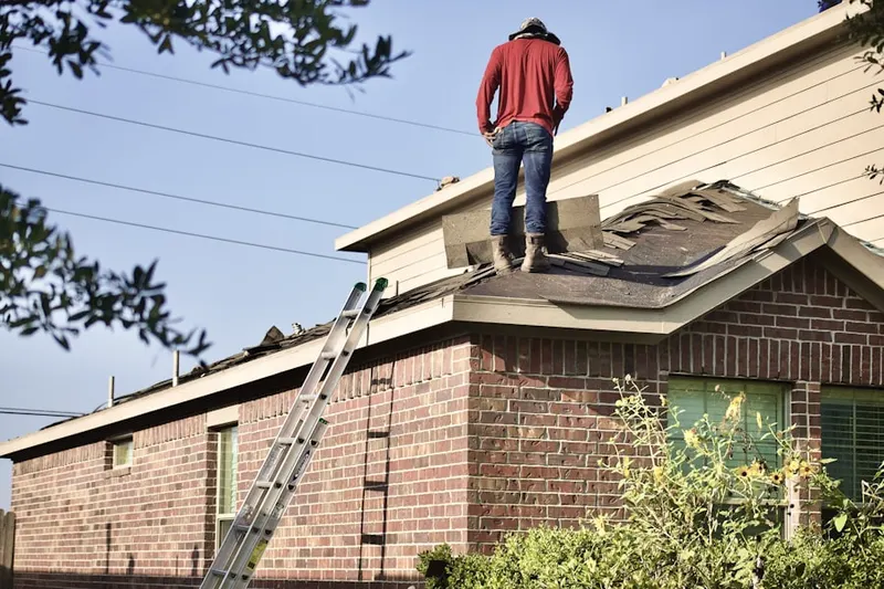 Professional roofer working on a residential roof in Boston